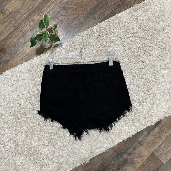 KanCan Black Edgy Vintage-Inspired High Rise Fringe Hem Cheeky Booty Shorts - Picture 3 of 4